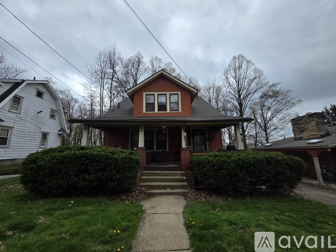 A house with a red roof and a front porch.