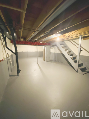 A staircase in a building with a logo that reads "avail" on the wall.