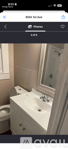 A white bathroom sink with a mirror above it.
