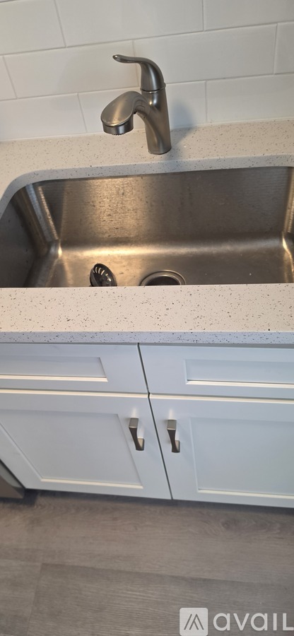 A kitchen with a sink and a cabinet.