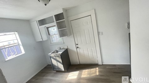 A kitchen area with a sink and a window.