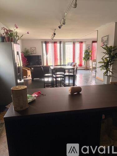 A kitchen with a black counter top and a white fridge.