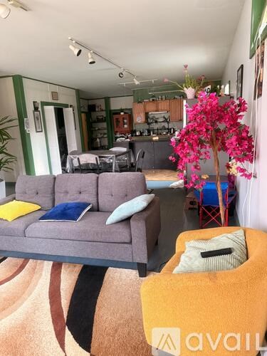 A living room with a grey sofa and a yellow chair.