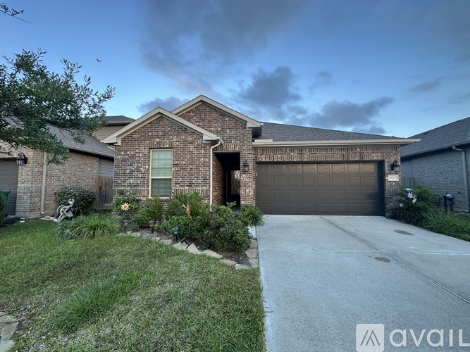 A house with a driveway and garage is available for sale.