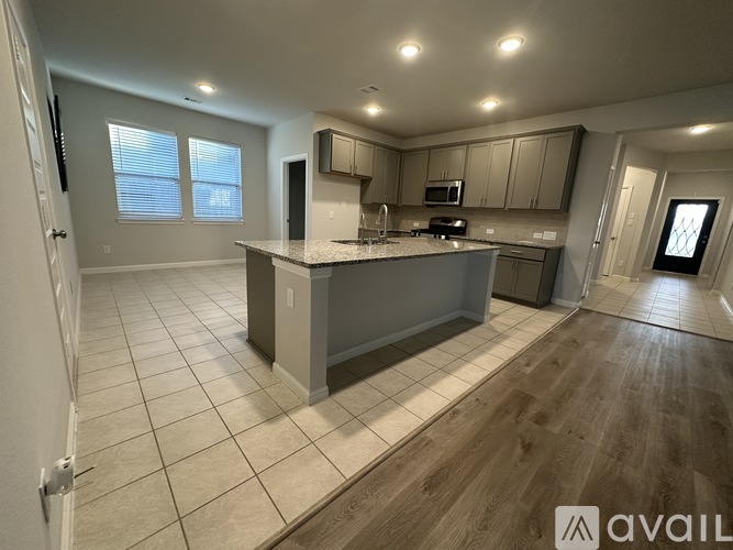 A kitchen with a large island in the middle of the room.