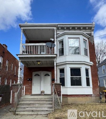 A two-story brick house with a white door and windows.