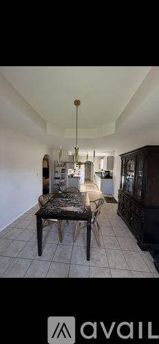A dining room with a table and chairs.