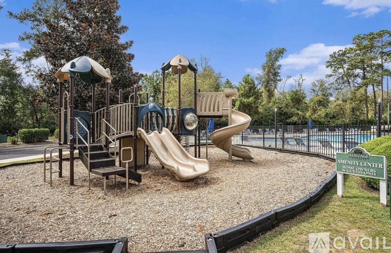 A playground with a slide, swings, and a climbing structure.