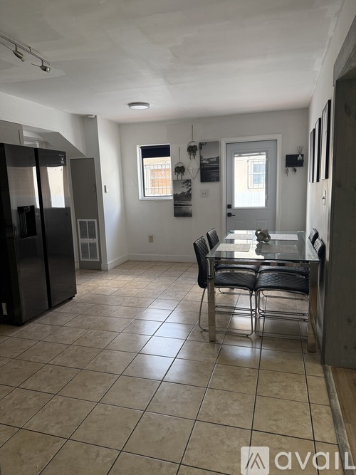 A kitchen with a table and chairs in the middle of the room.