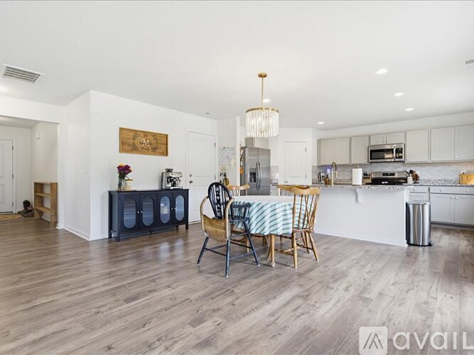 A modern kitchen with a dining table set up.