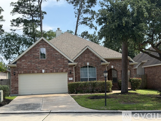 A house with a white garage door and a brick facade.
