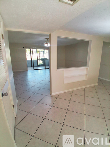 A room with a tiled floor and a window.