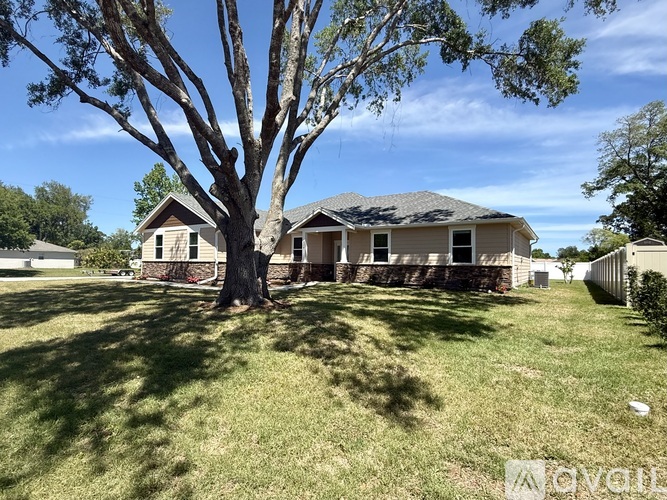 A house with a tree in front of it.