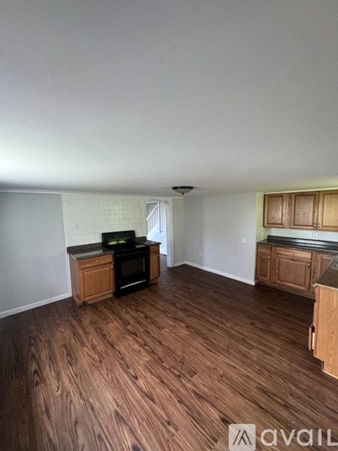 A kitchen with wooden floors and cabinets is available for rent.