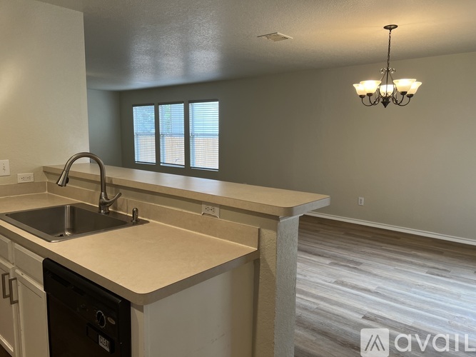A kitchen with a sink and a window.