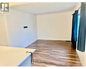 A room with wooden flooring and a white countertop.