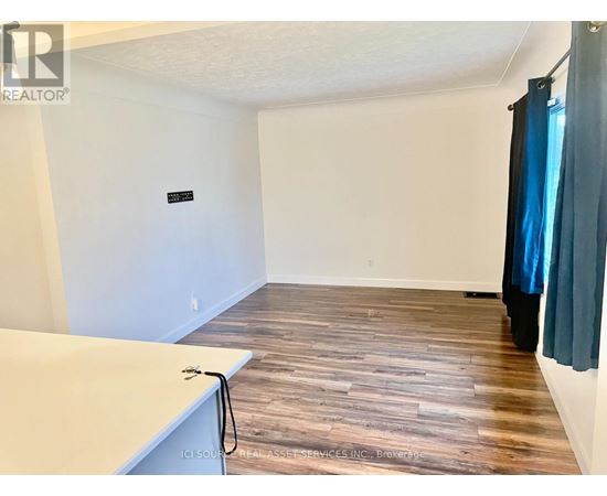 A room with wooden flooring and a white countertop.