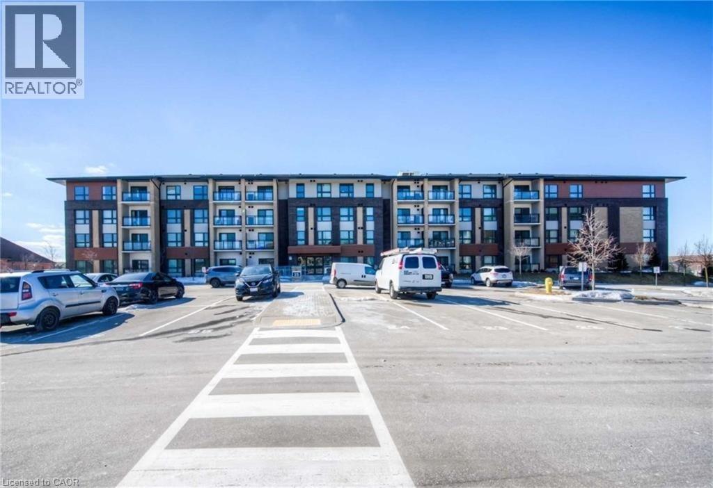 A parking lot with cars and a building in the background.