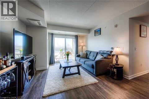 A living room with a grey couch and a flat screen TV.