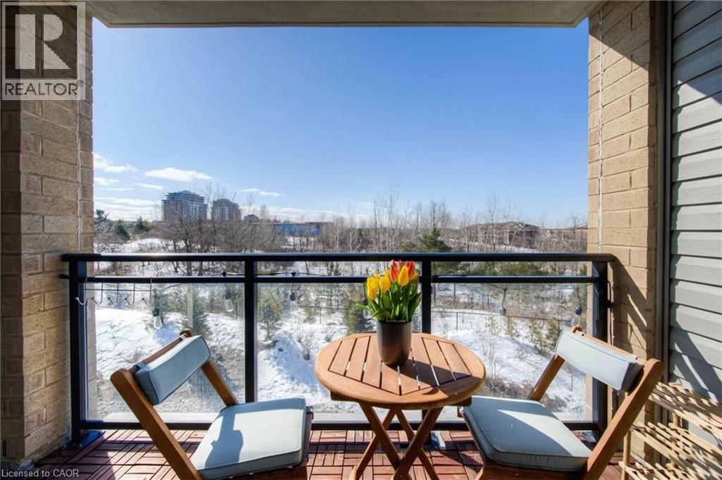 A balcony with a table and chairs overlooking a snowy landscape.