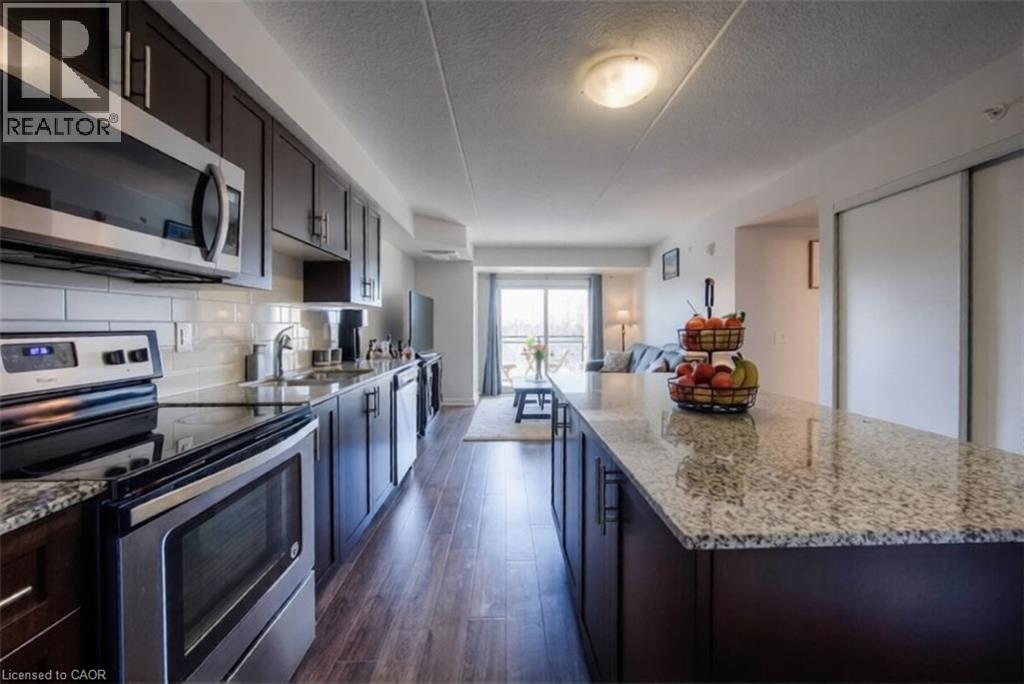 A kitchen with dark wood cabinets and granite countertops.