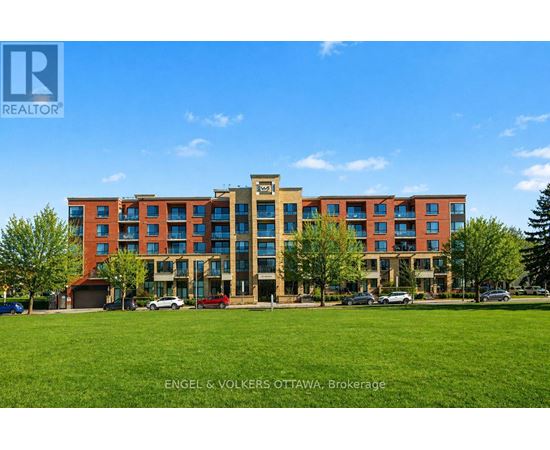 A large multi-story building with a grassy area in front.