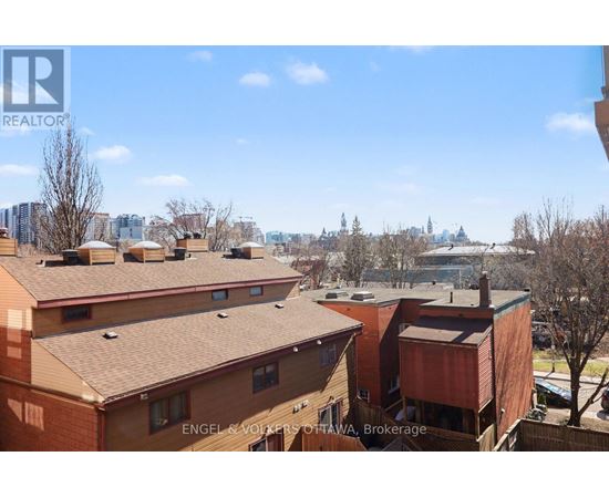 Apartment buildings with a view of a city skyline in the background.