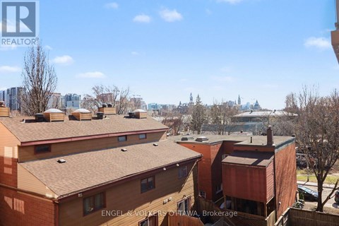 Apartment buildings with a view of a city skyline in the background.