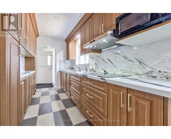 A kitchen with wooden cabinets and a checkered floor.