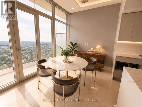 A dining room with a table and chairs with a view of the city.