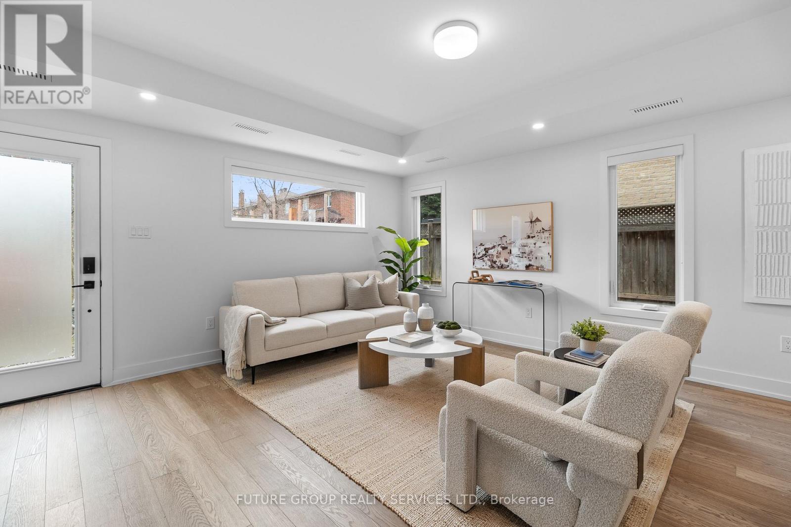 A living room with a couch, chairs, and a coffee table.