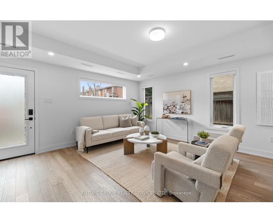 A living room with a couch, chairs, and a coffee table.