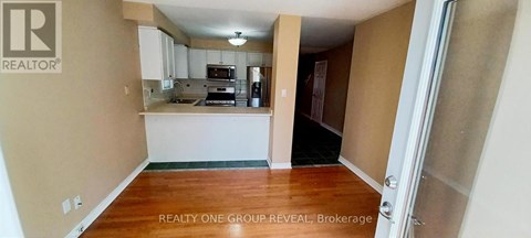 A realtor photo of a kitchen and living room.