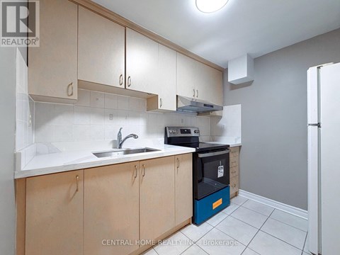 A kitchen with wooden cabinets and a blue dishwasher.