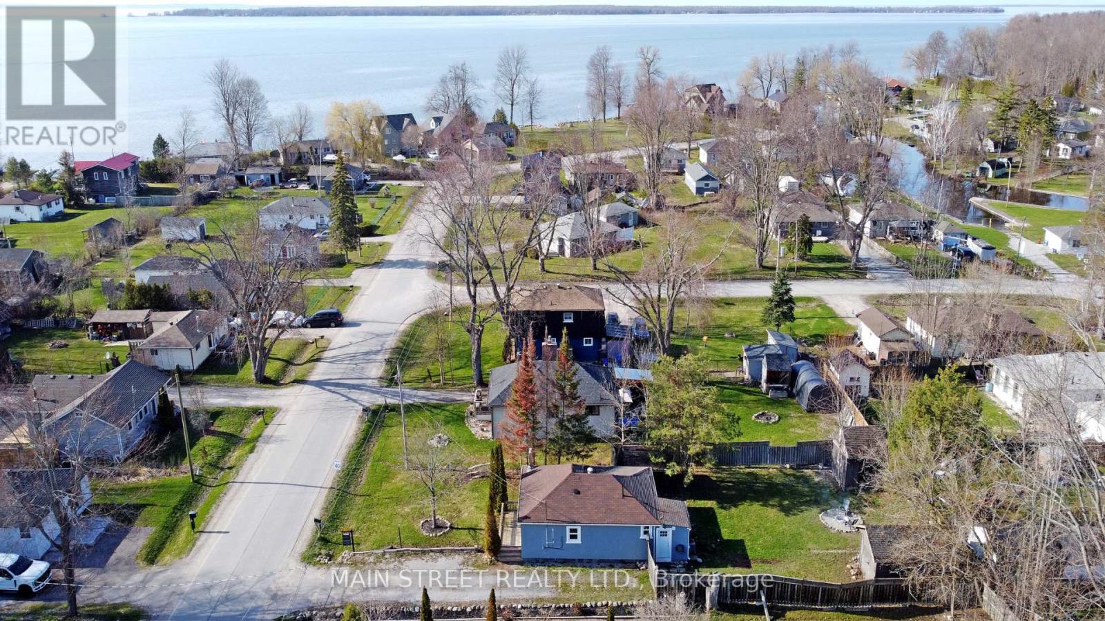 A Main Street Realty Ltd. logo is superimposed on an aerial view of a residential neighborhood.