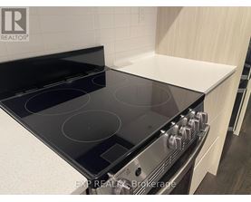 A modern kitchen with a black stove top oven.