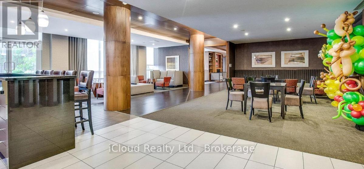 A large open living room with a bar area and a dining table.
