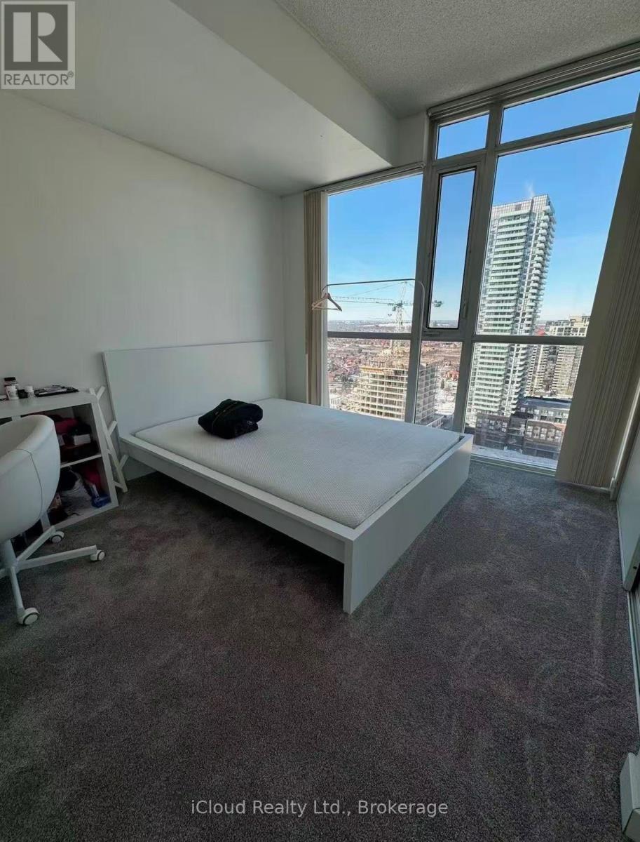 A bedroom with a large bed and a view of the city.