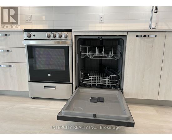 A modern kitchen with a stainless steel oven and a dishwasher.