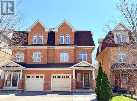 A large red brick house with a white garage door.