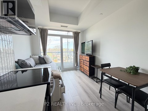 A modern kitchen with a dining table and chairs.