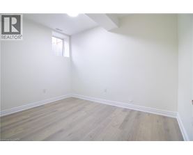 A room with wooden flooring and white walls.