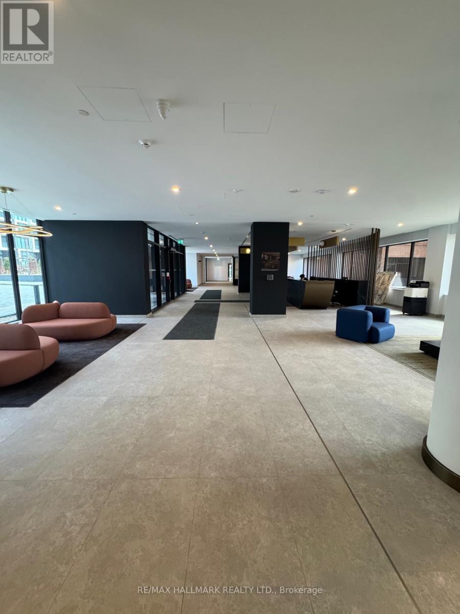 A spacious lobby with a marble floor and seating areas.