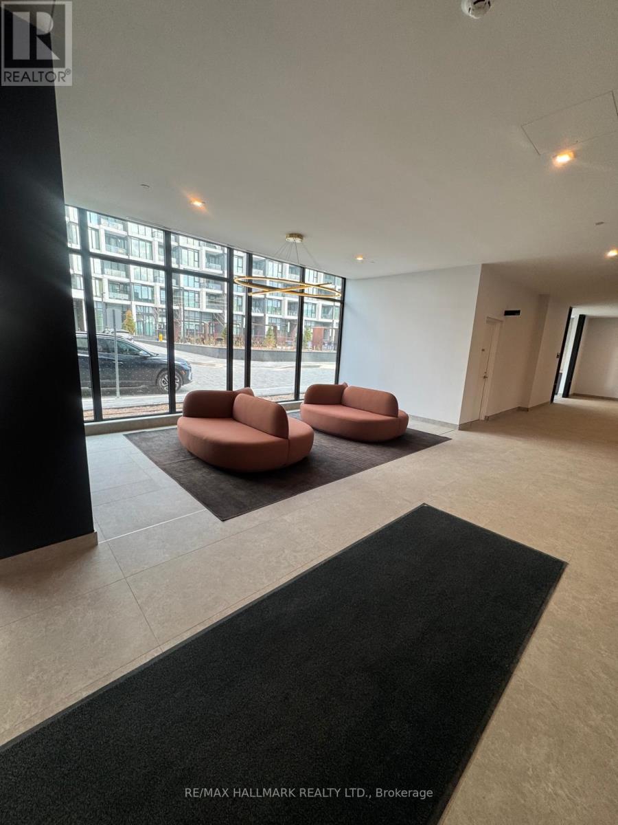 A black carpet is on the floor of a room with two orange chairs and a ceiling fan.