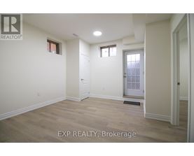 A room with a door and a window is for rent.