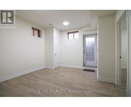 A room with a door and a window is for rent.