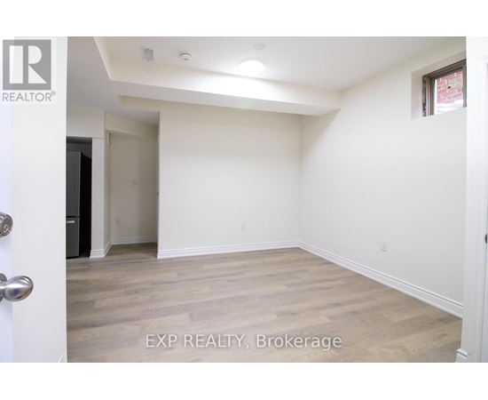 A room with EXP REALTY, Brokerage written on the floor.