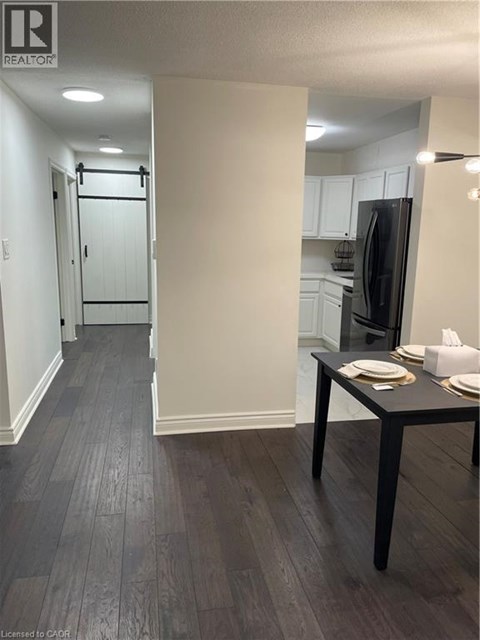 A kitchen with a table and chairs in the middle of the room.