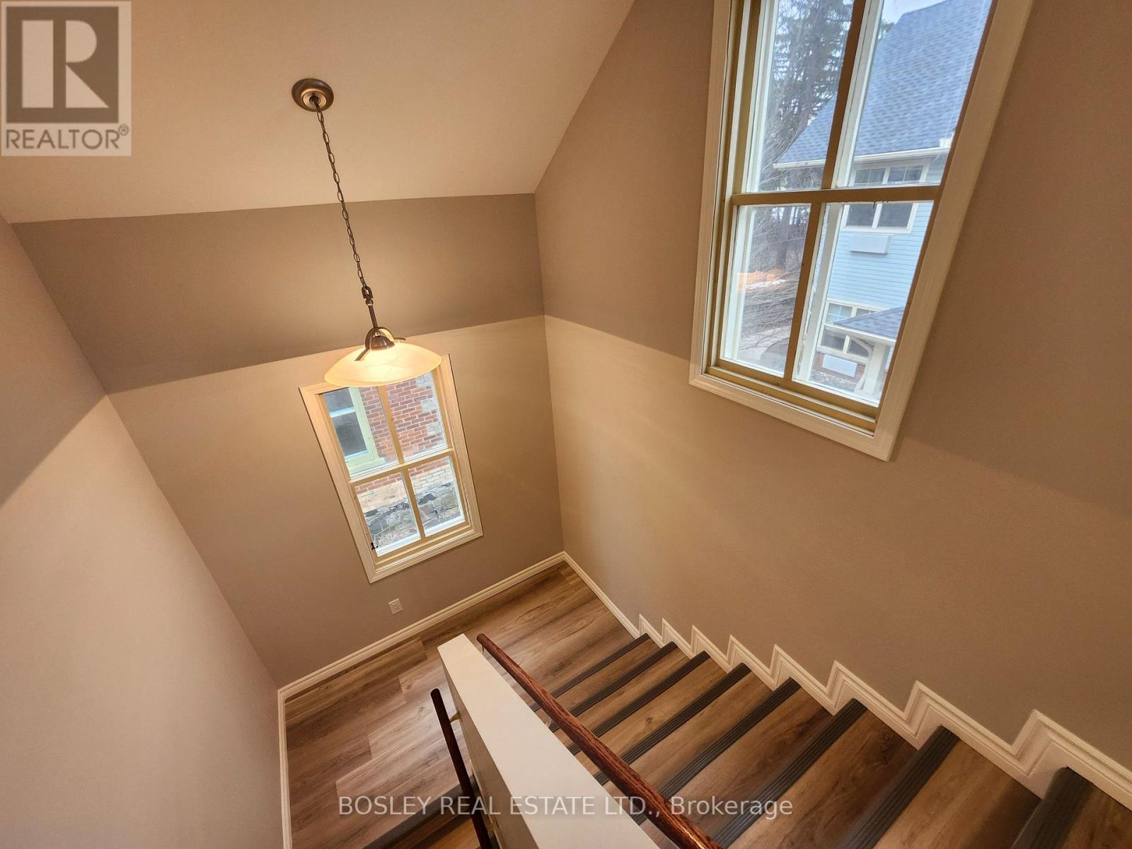 A staircase with a light hanging from the ceiling.