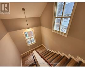 A staircase with a light hanging from the ceiling.